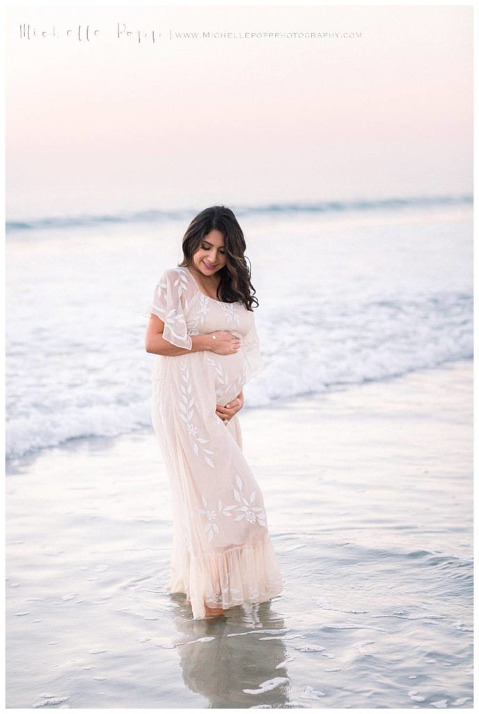 pregnant woman at the beach at sunset