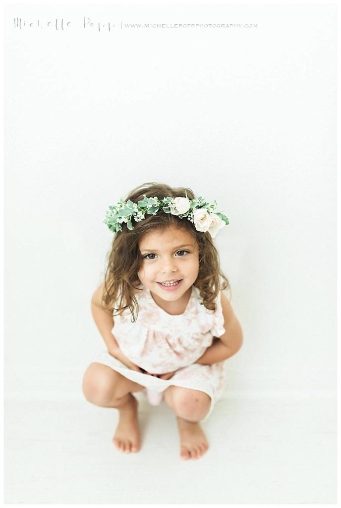 little girl sitting and smiling at camera