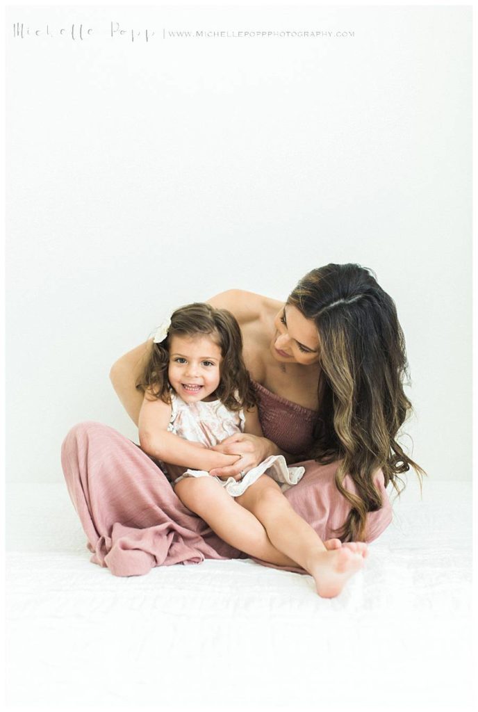 mom holding daughter in lap