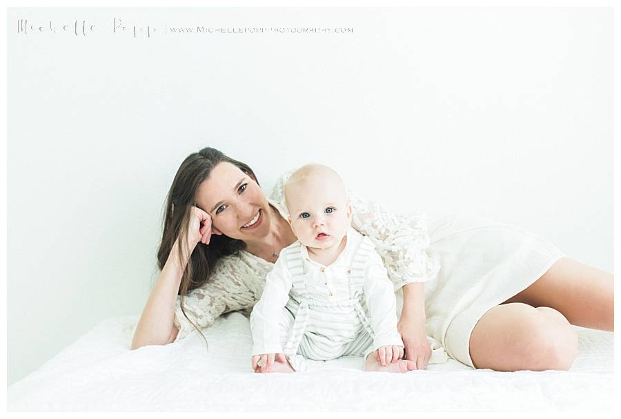 mom laying on side baby sitting up