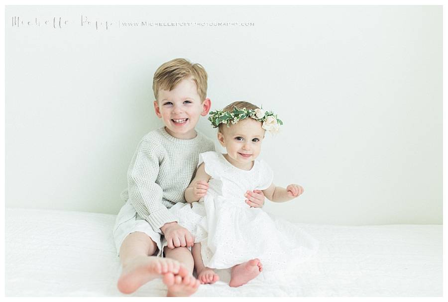 brother holding sister in lap 