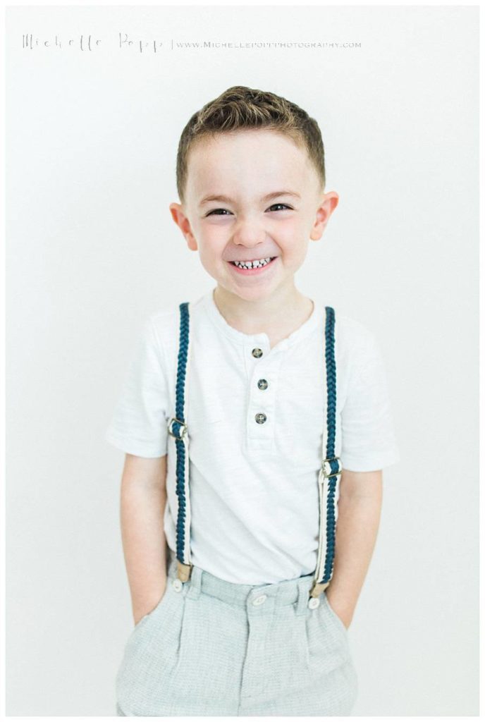little boy in white tee and blue trousers