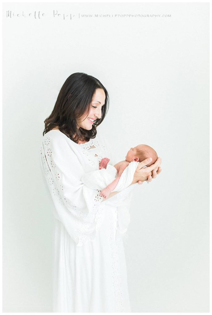 mom staring happily at new baby