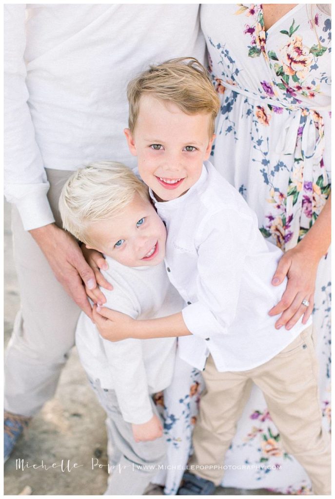 toddler boys in white shirts hugging