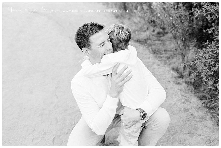 black and white of dad hugging son