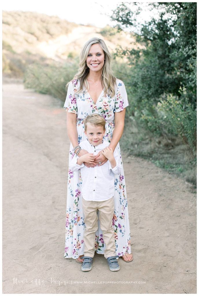 mom standing with son smiling