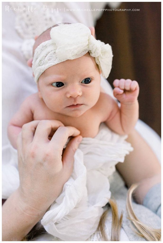 newborn baby girl in white headband