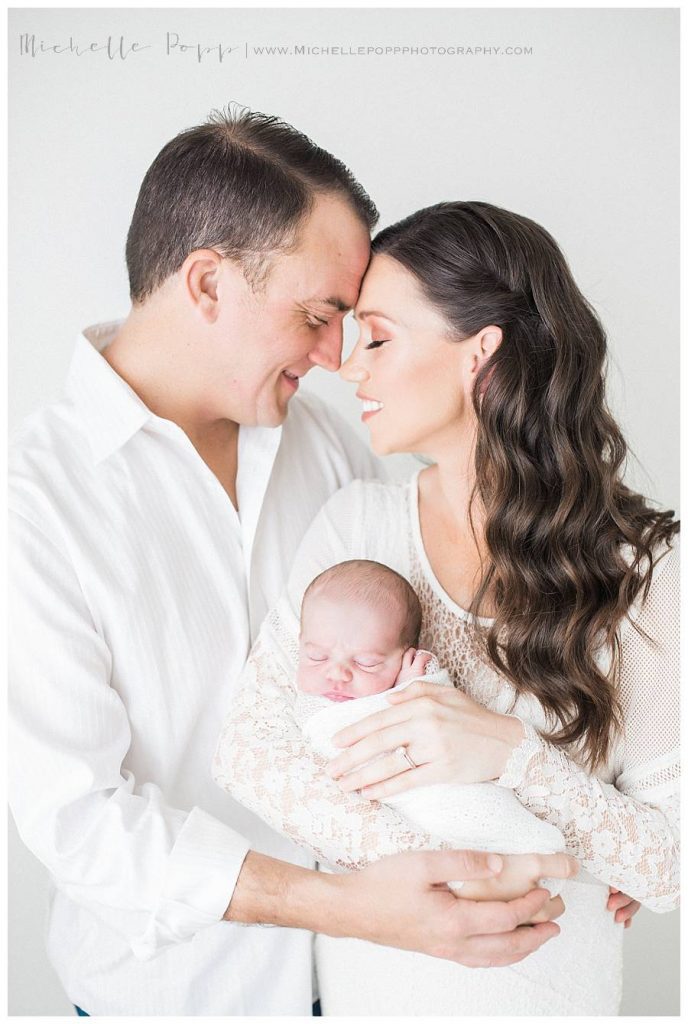 mom and dad holding new baby