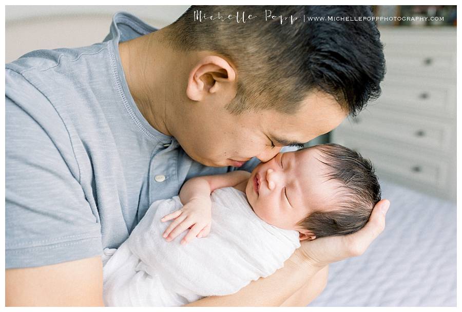 dad holding baby girl in arms