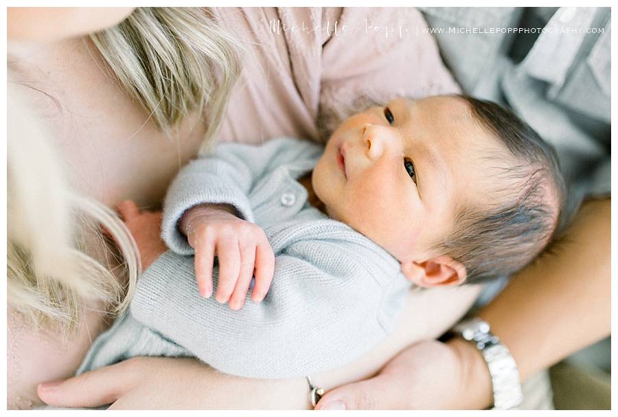 newborn baby boy in blue onesie