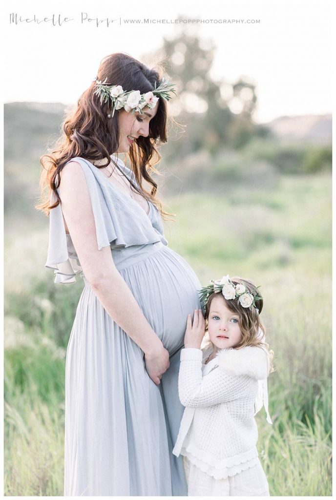 pregnant mom and daughter snuggling