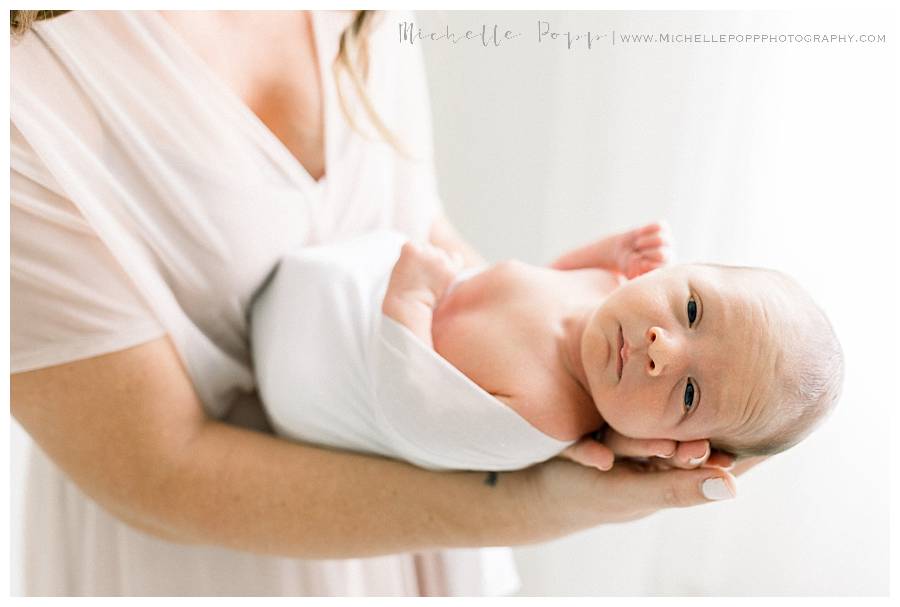 newborn baby in moms hands