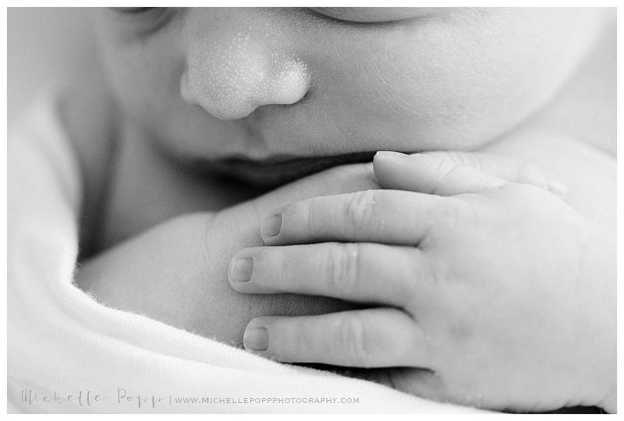 newborn baby hands up close