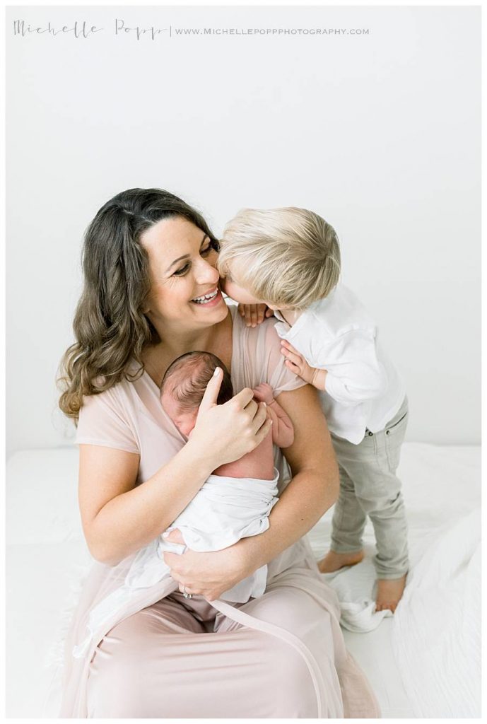 toddler boy giving mom a kiss