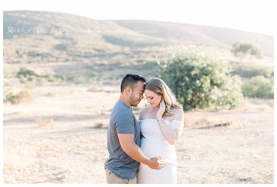 maternity photo in a field at sunset