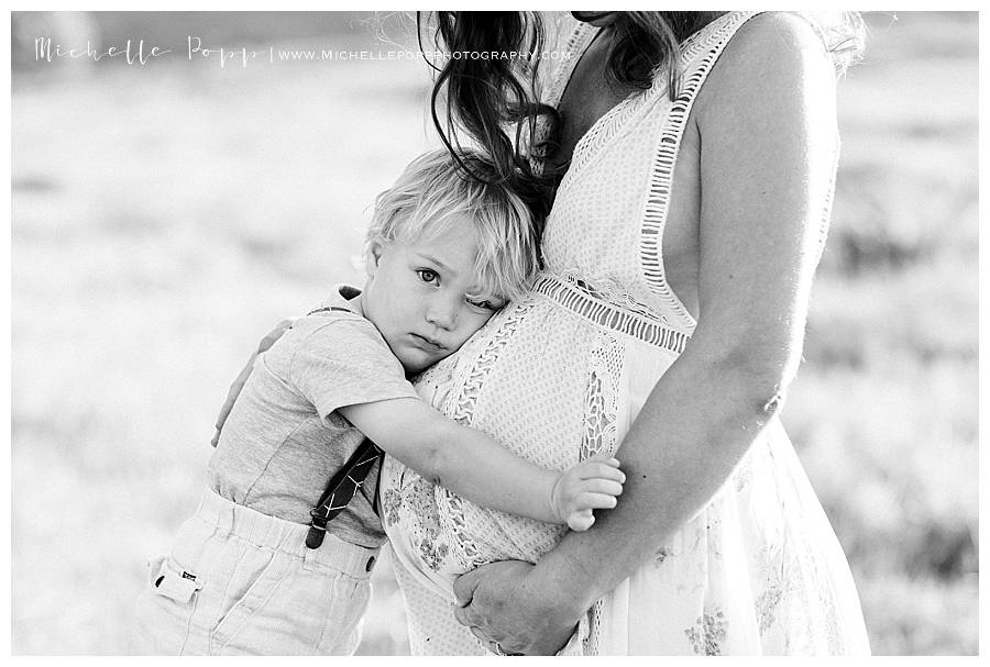 son snuggling mom's belly