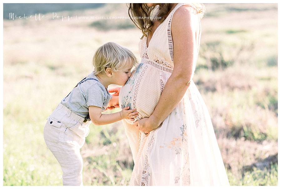 son kissing mom's belly