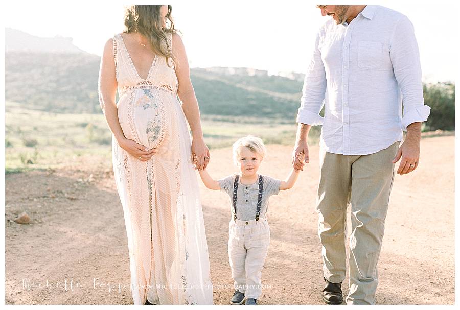 walking in field with mom and dad