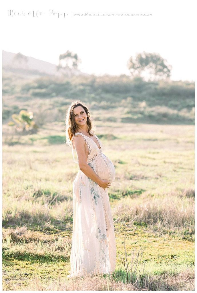 maternity photo of mom in field glowing