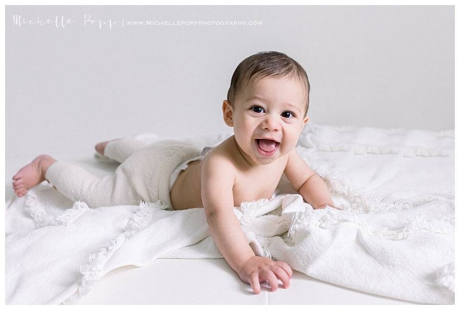 baby boy doing tummy time smiling