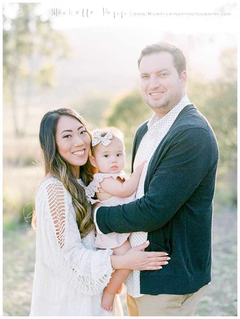 family smiling at camera