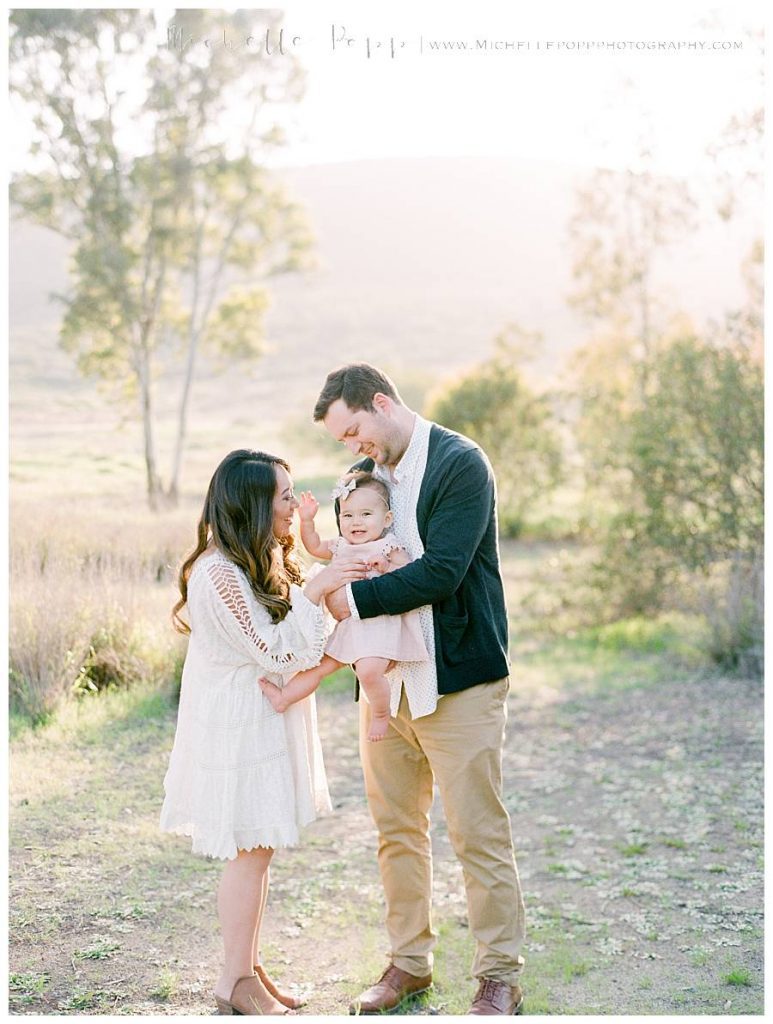 parents smiling at daughter 