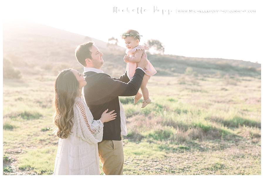 mom & dad playing with daughter