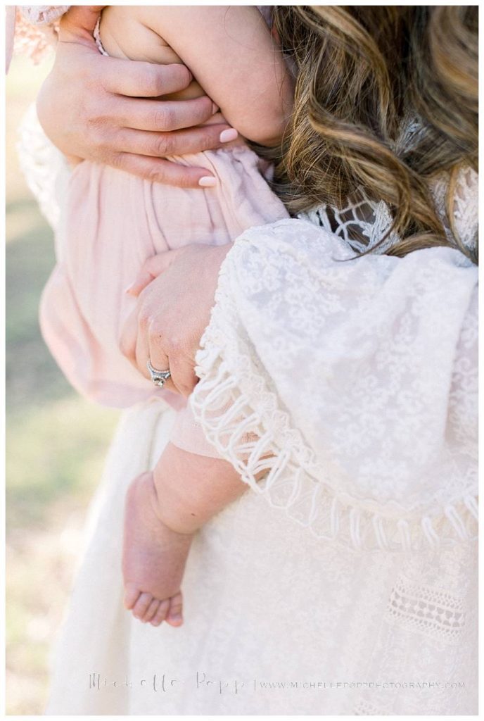 close up of baby on mom's hip