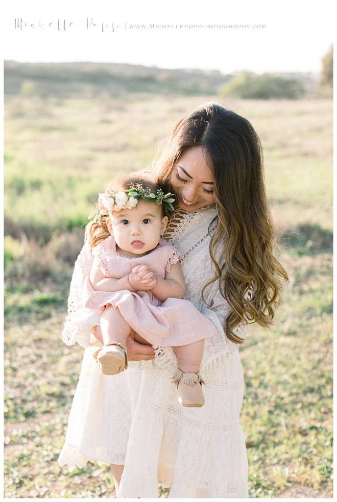 mom snuggling baby girl