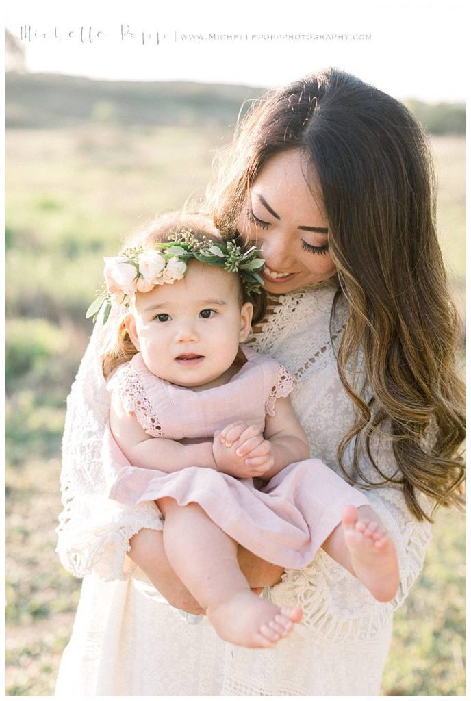 mom smiling down at baby girl