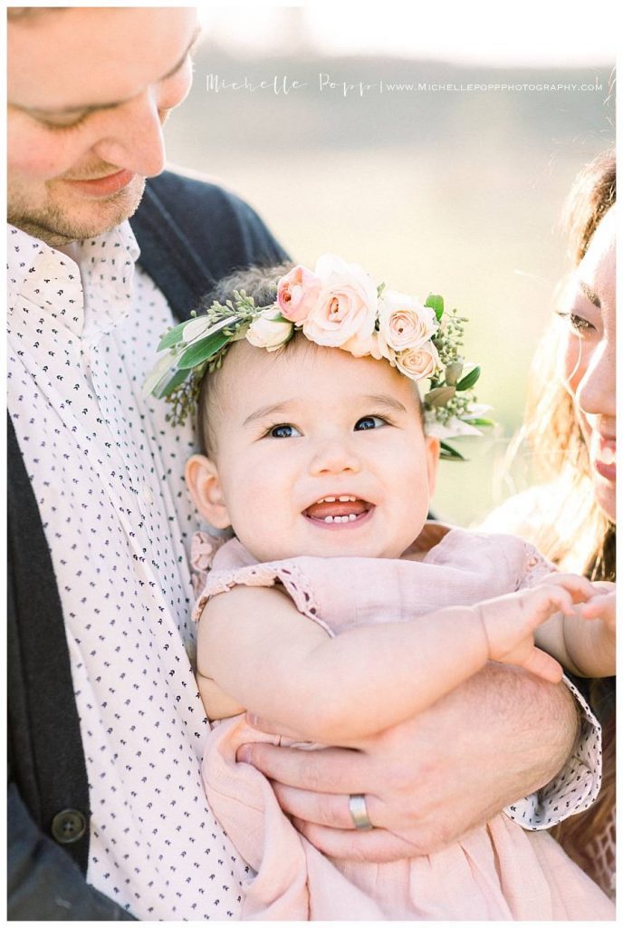 close of baby smiling with floral crown