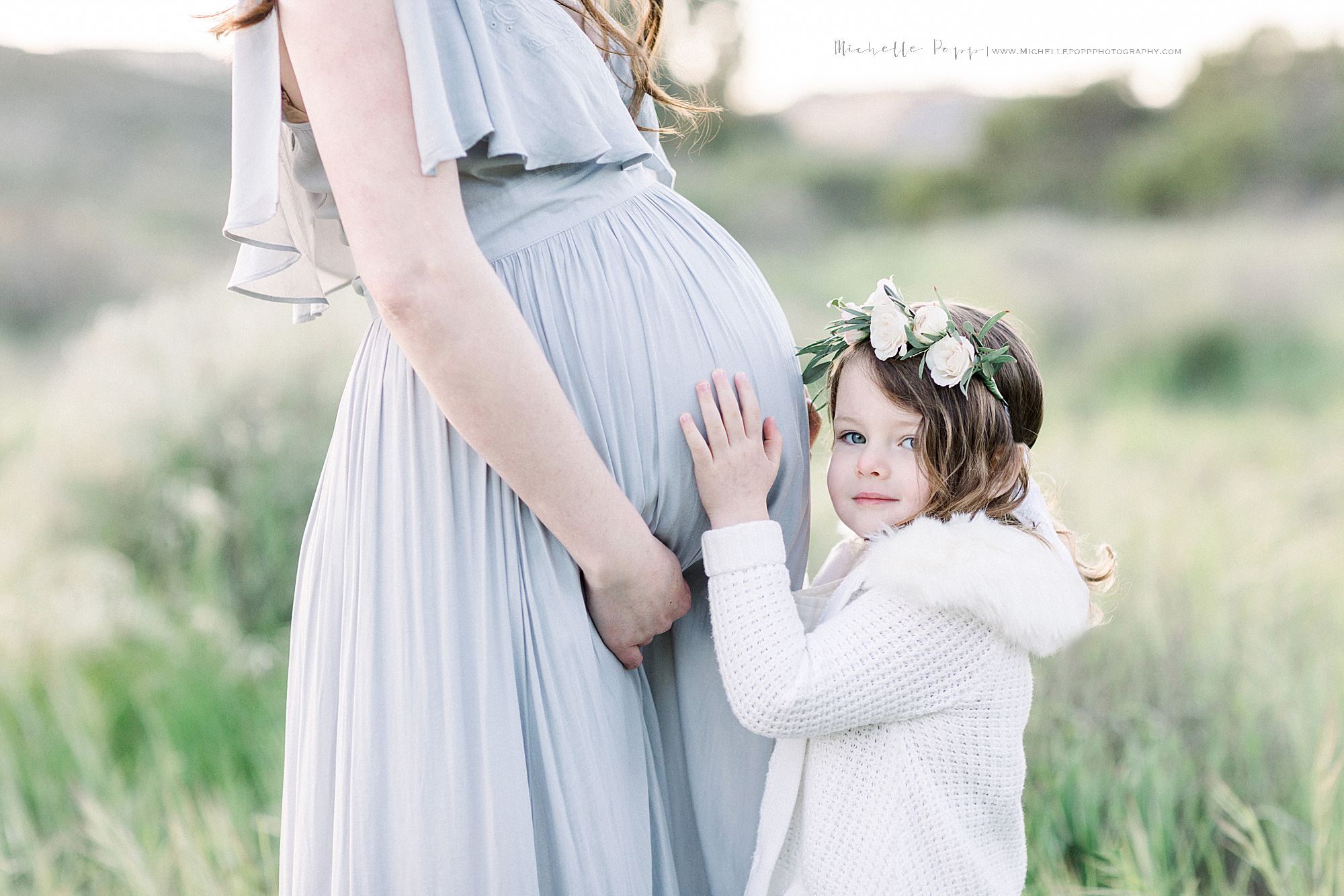 daughter hugging mom's belly