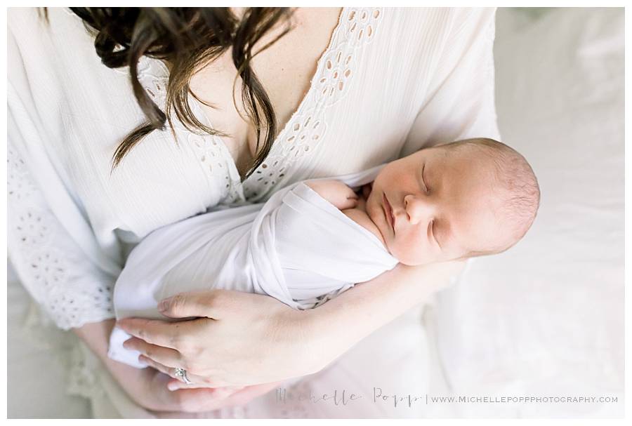 mom holding newborn baby in arms