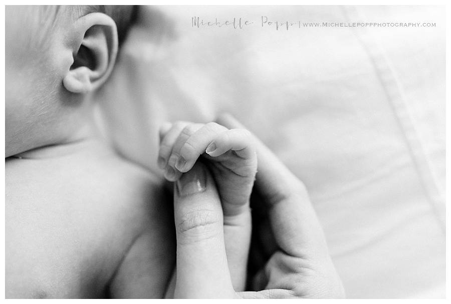 mom holding babys fingers