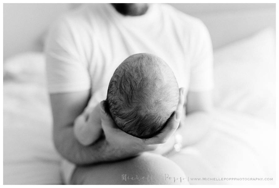 dad holding newborn baby's head