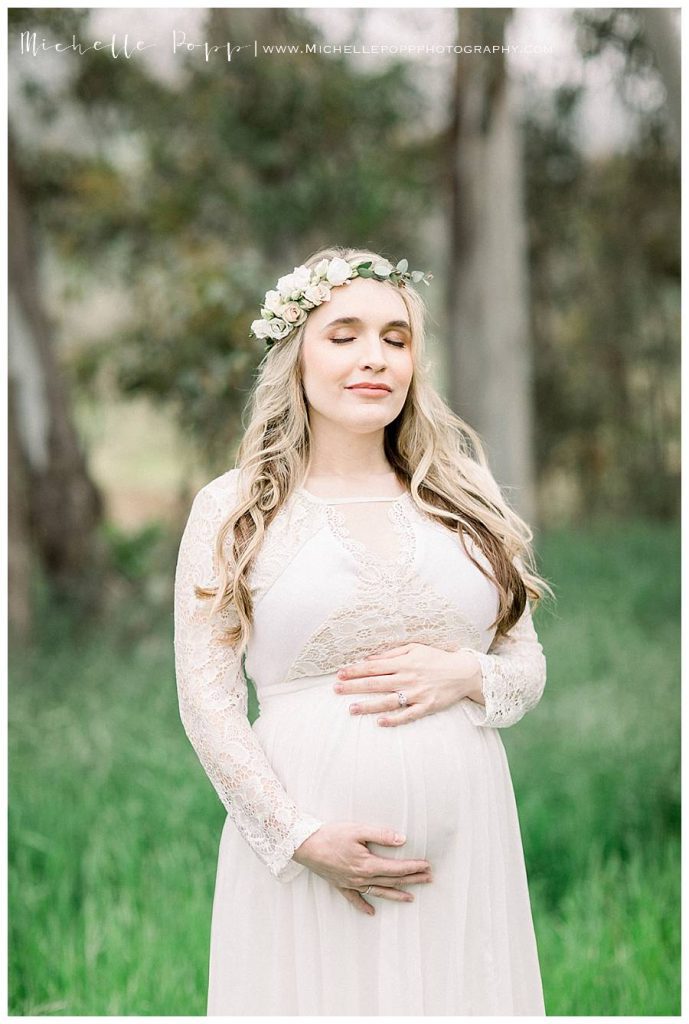 expectant mother in white dress eyes closed