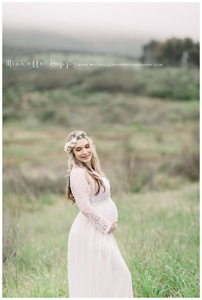 pregnant woman in white dress in a field