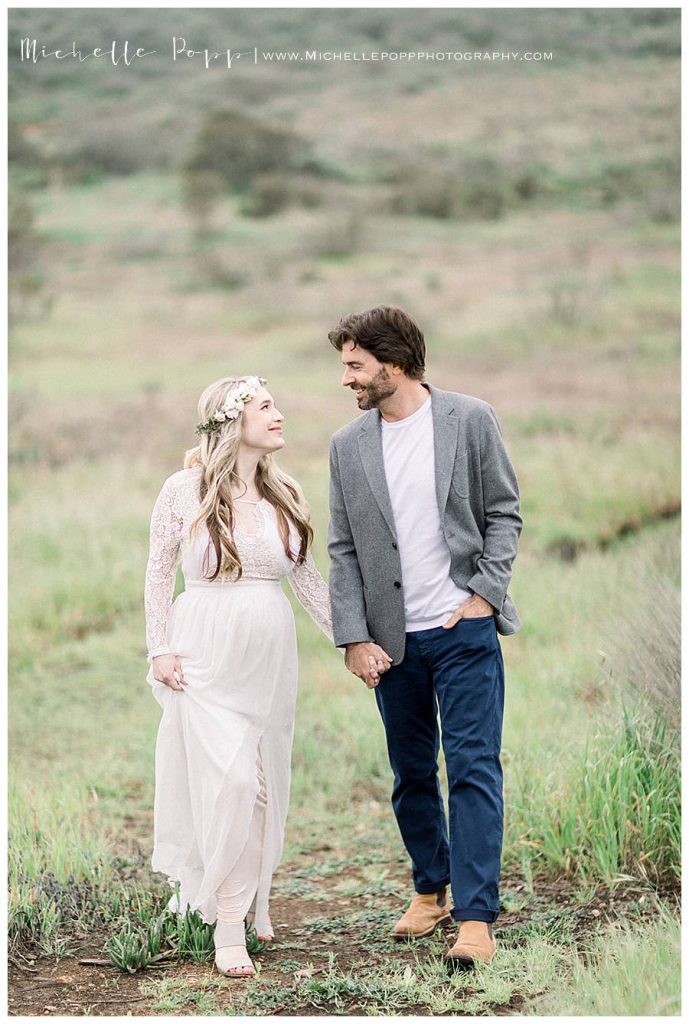 couple walking towards camera looking at each other