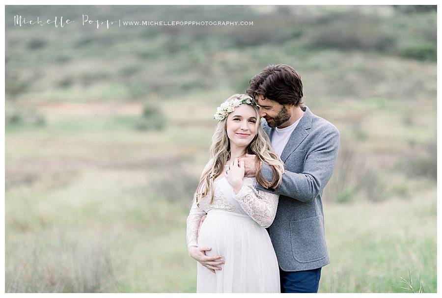 woman looking at camera while man holds her