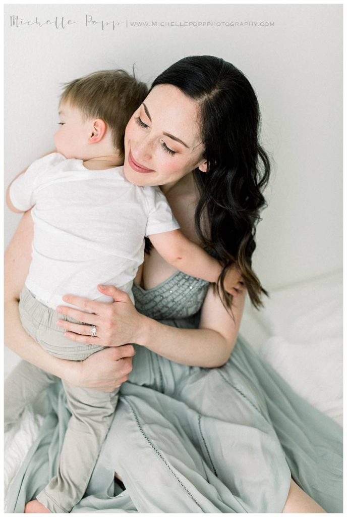 mom hugging son on bed