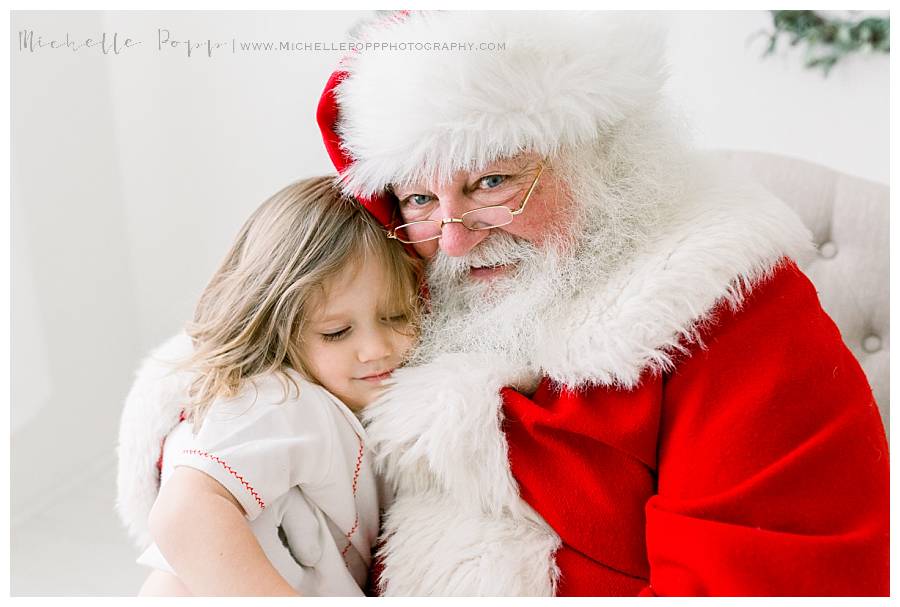 boy snuggling santa claus