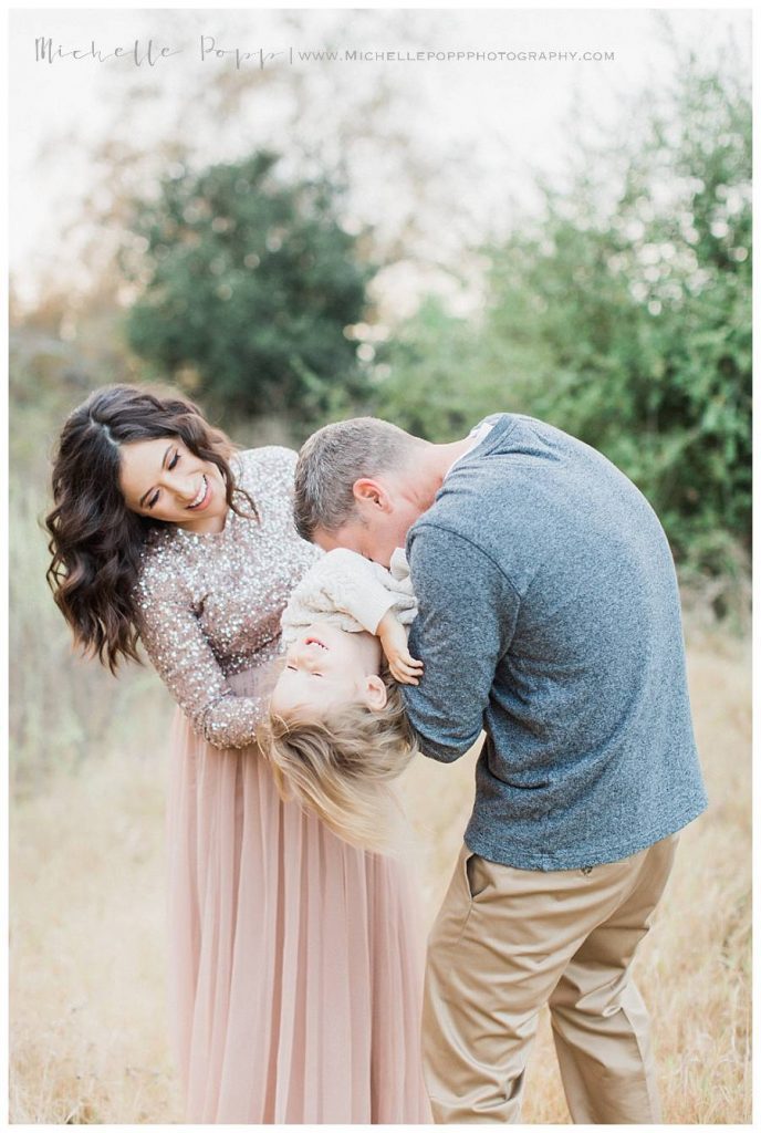 mom and dad tickling son