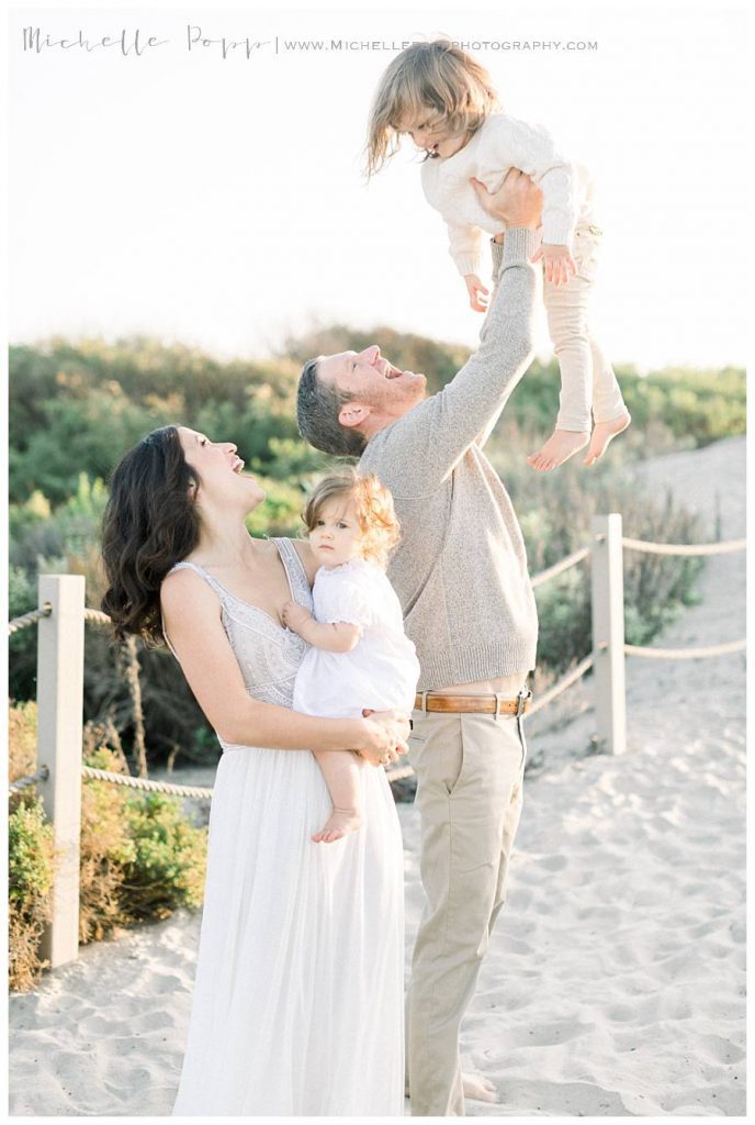 mom and dad with two kids at beach