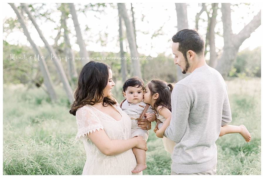 mom and dad holding two babies