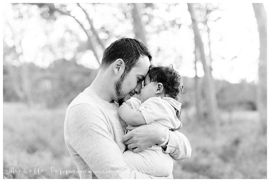 dad snuggling baby boy