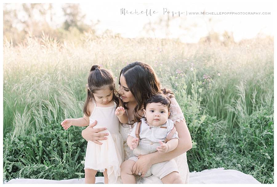 mom holding two babies in arms