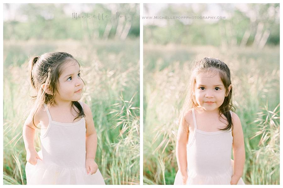 little girl in a white dress in field