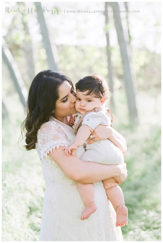 mom holding baby boy on chest