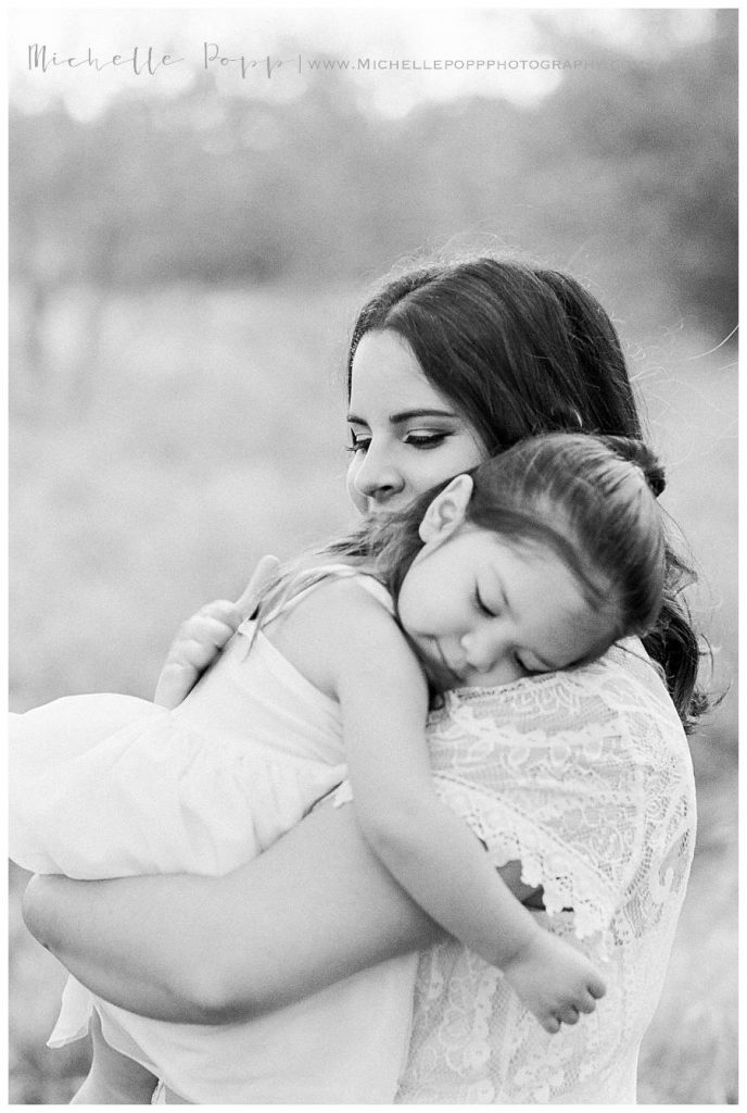 toddler girl hugging mom