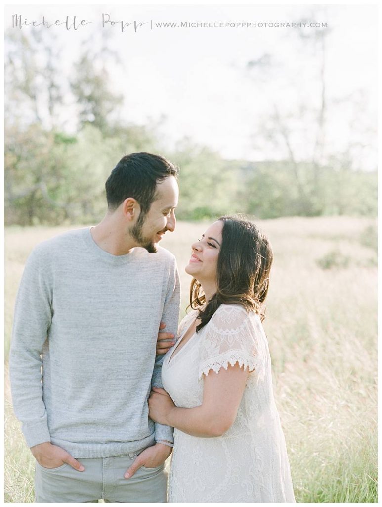 woman and man in field hugging